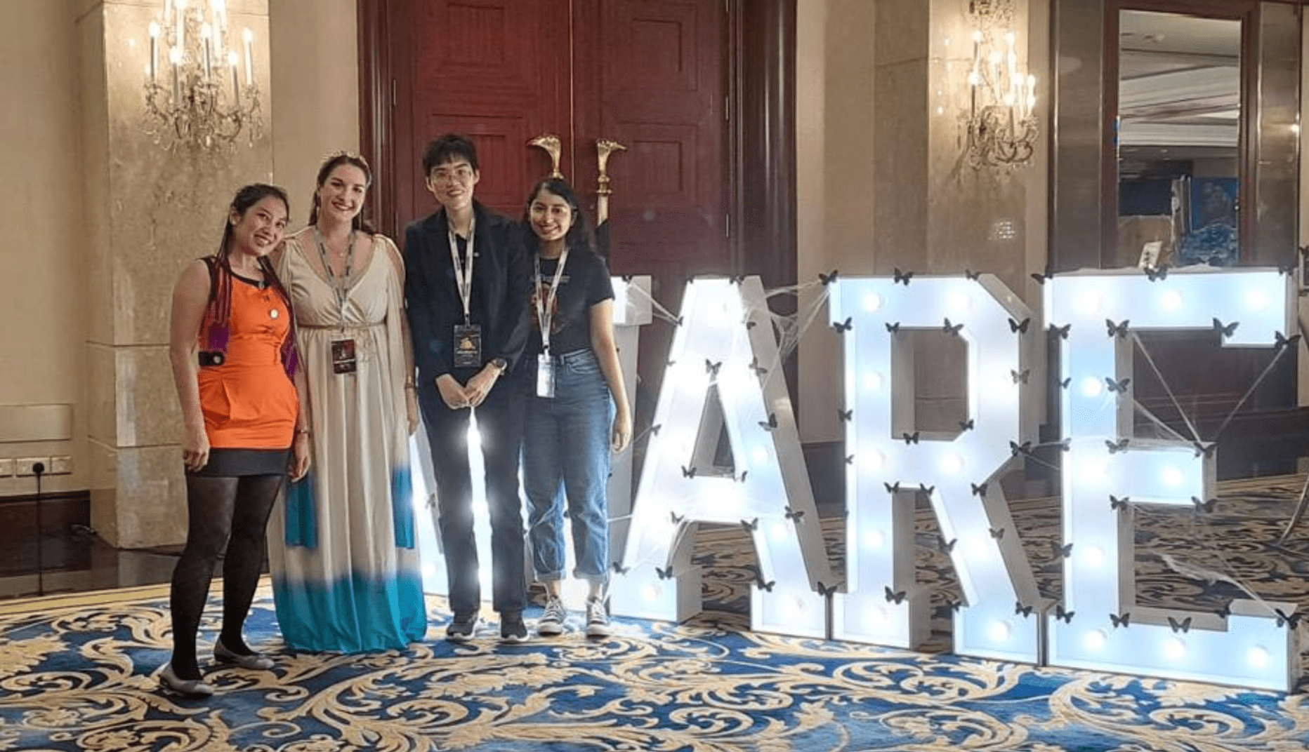 Group photo in front of AWARE sign at AWARE annual ball