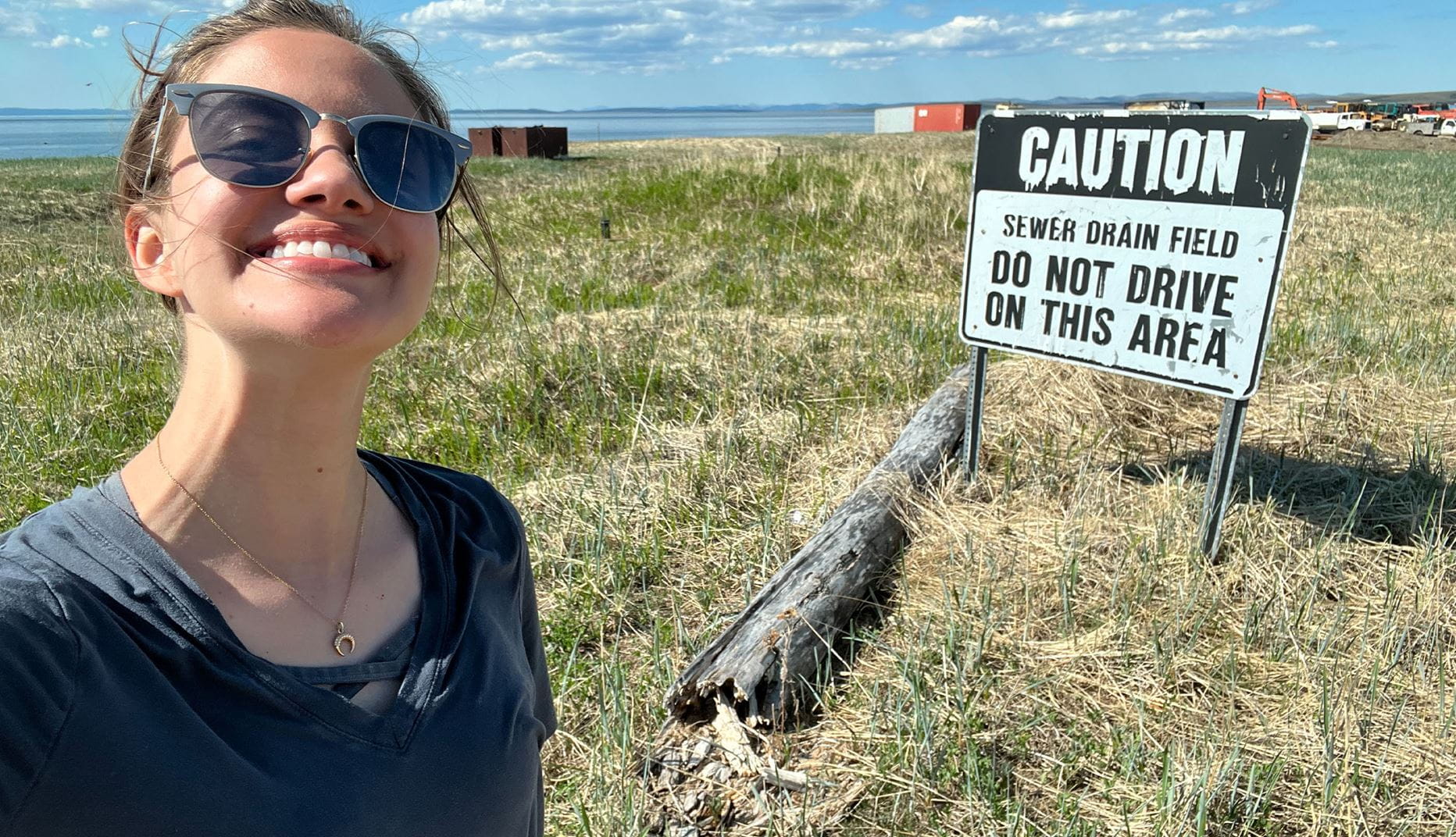 Theresa in front of caution sign