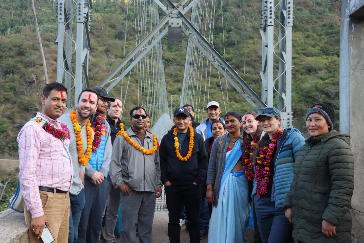 group standing at bridge wearing garlands