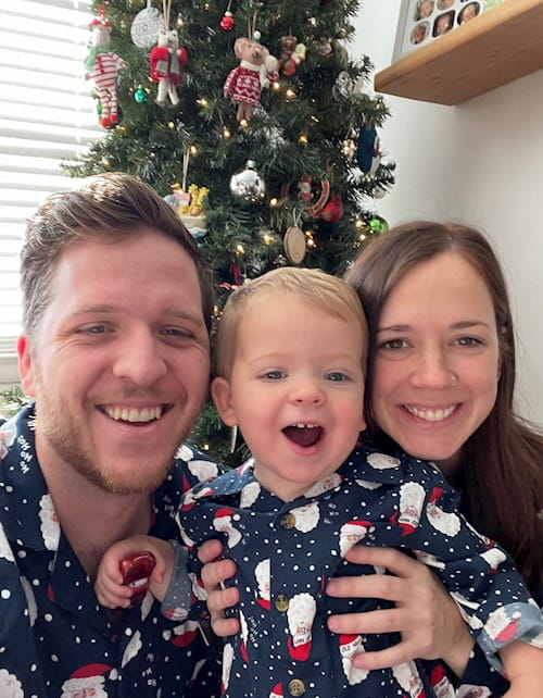Jake with wife and child in holiday pajamas
