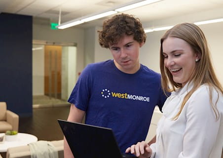 millennials working together on a laptop