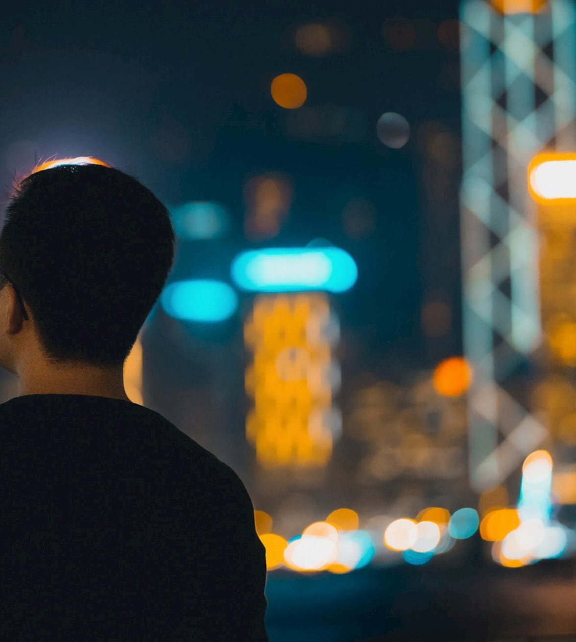 Person looking out at nighttime city-scape