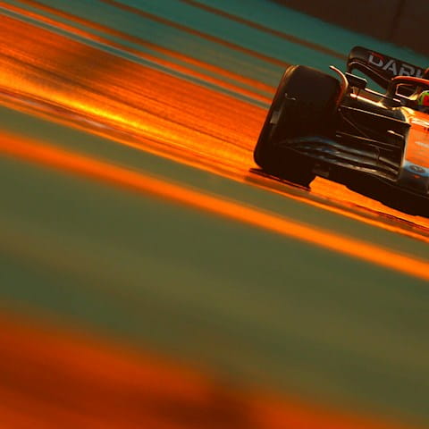 formula 1 car on the track during sunset