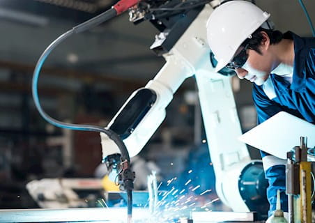 man working with robotic arm