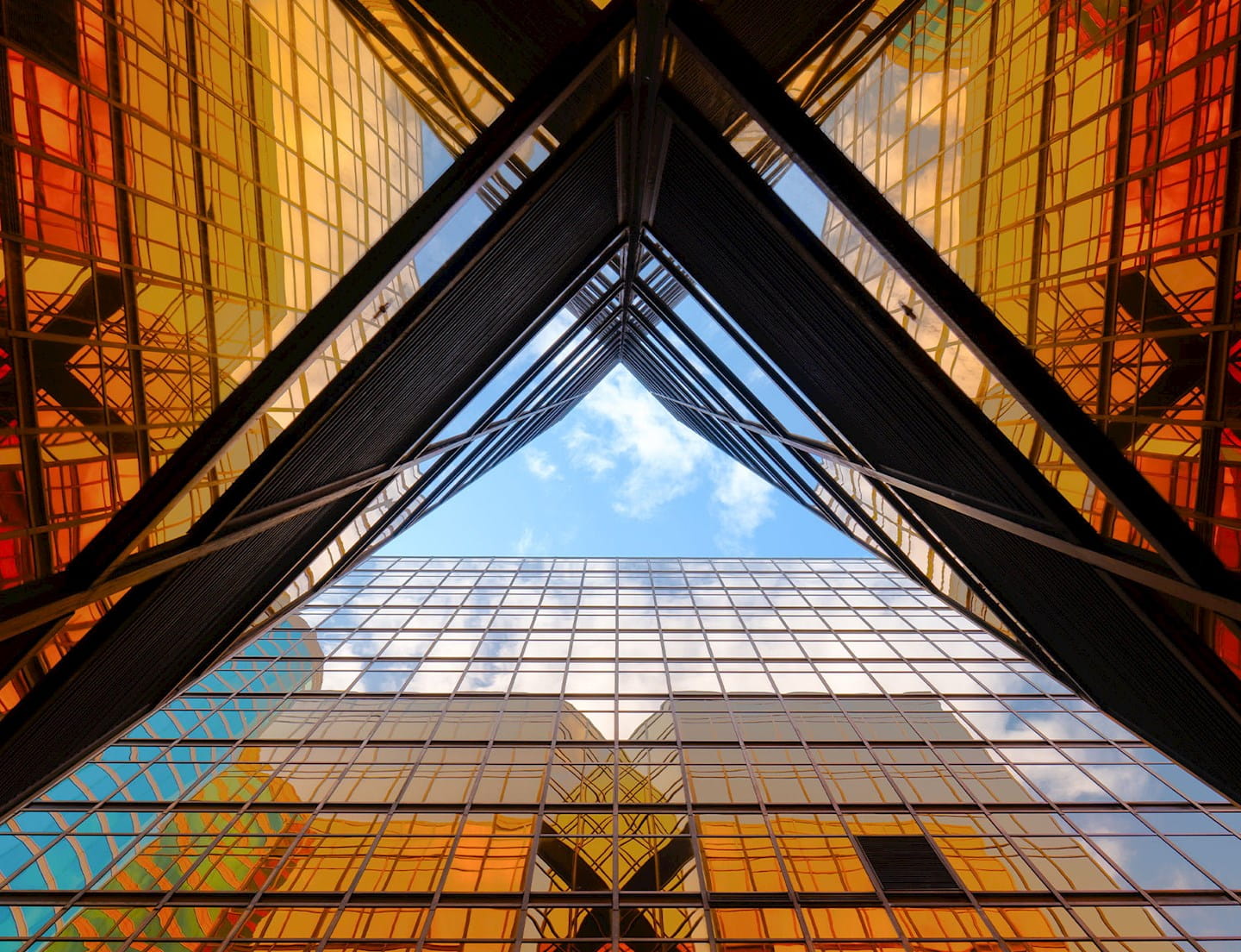 picture of a city sky scrapper from the ground looking up