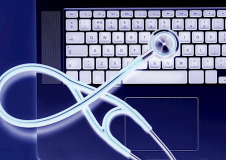 Keyboard with a stethoscope looping over it