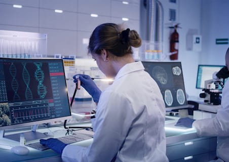 female clinical researcher in a lab running tests